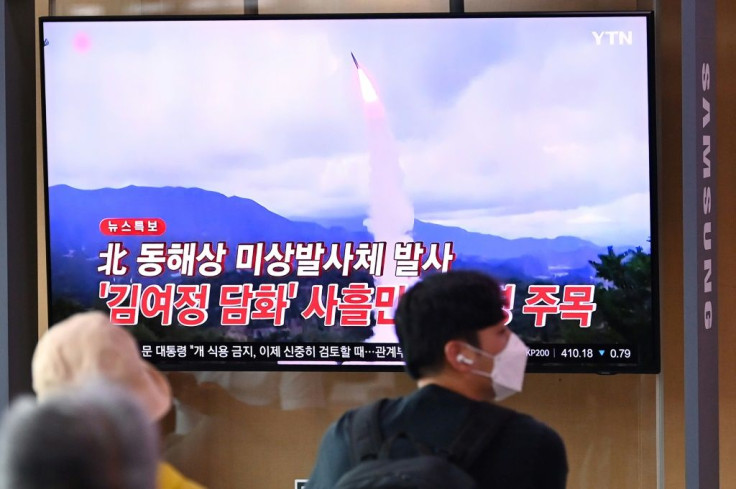 People watch a television news broadcast showing file footage of a North Korean missile test, at a railway station in Seoul on September 28, 2021, after North Korea fired an 'unidentified projectile' into the sea off its east coast