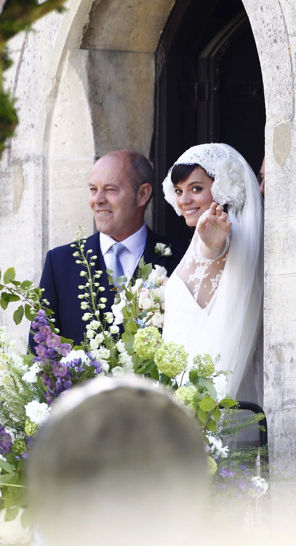British singer Lily Allen R smiles after marrying Sam Cooper as the couple leaves St James the Great Church in Cranham, Goucestershire, western England, June 11, 2011.
