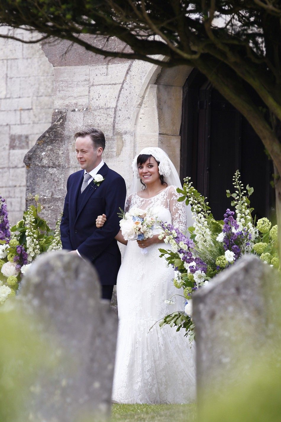 British Singer Lily Allen smiles after marrying Sam Cooper as the couple leaves St James the Great Church in Cranham, Goucestershire, western England, June 11, 2011.