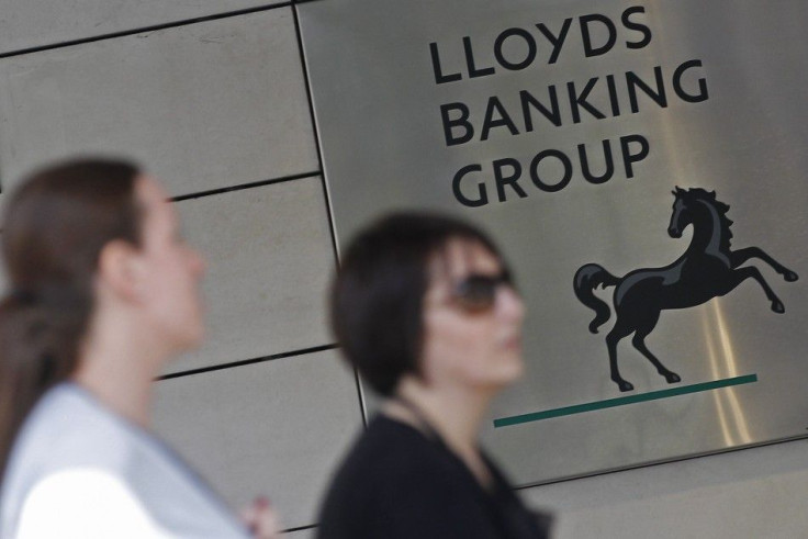 Pedestrians pass the head office of Lloyds Banking Group in central London