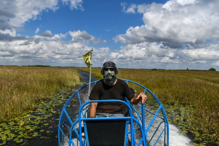 Tourist airboat captain Umberto Lazaro Gimenez, hovers over Everglades National Park, Florida on September 30, 2021