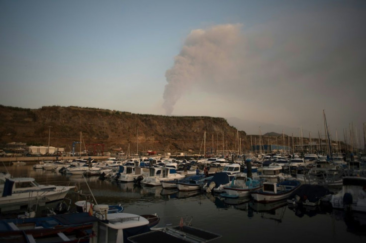 Small boats are moored in the port of Tazacorte as the volcano spews lava, ash and smoke -- but locals don't want to leave