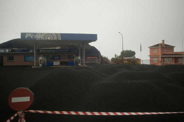 A petrol station covered with ash at Jedey on La Palma -- which has gained 75 acres of surface area due to the lava pouring off a 500-metre stretch of coastline into the sea, creating a vast delta