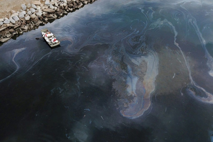 Environmental response crews are cleaning up oil near the Talbert Marsh and Santa Ana River mouth