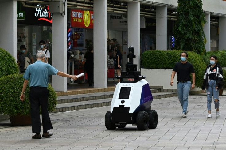 Singapore is trialling robots that patrol the streets looking for people who are smoking in prohibited areas, improperly parking bicycles, or breaching Covid rules