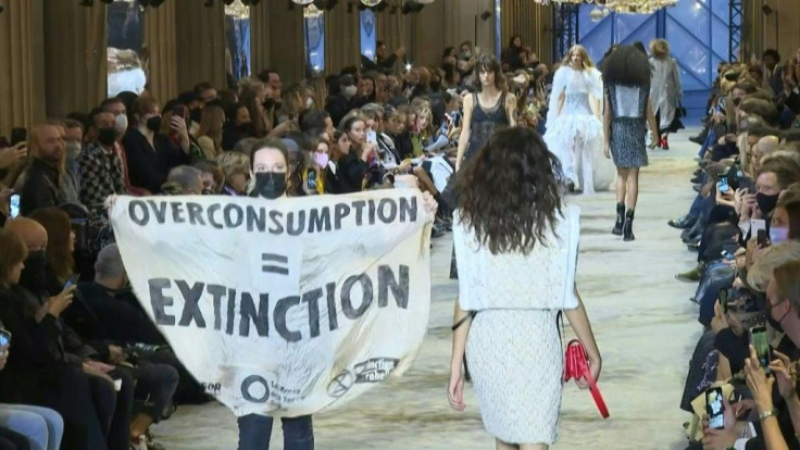 Climate activists burst onto the catwalk brandishing banners reading "Overconsumption = extinction" at Louis Vuitton's Paris Fashion Week show.Extinction Rebellion, Friends of the Earth and Youth For Climate said in a statement that around 30 people wer