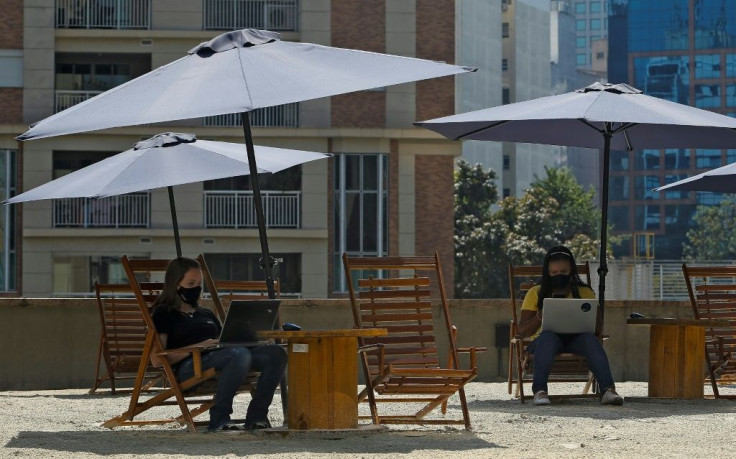 Parasols and deck chairs bring a beach feel to a coworking space on Sao Paulo's Paulista Avenue