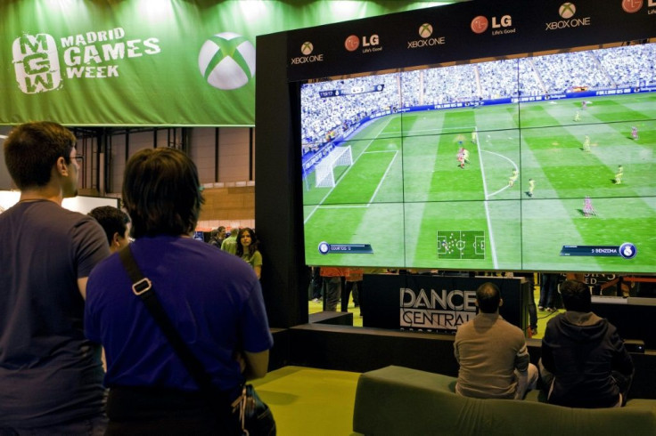 Visitors play a FIFA football video game in Madrid, Spain in October 2014