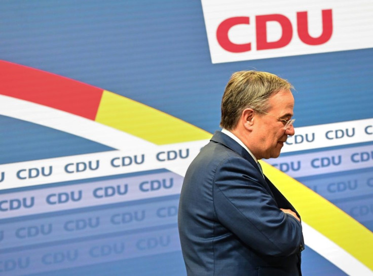 The leader of Germany's conservative Christian Democratic Union (CDU) party Armin Laschet leaves the stage after giving a statement in Berlin on October 7, 2021