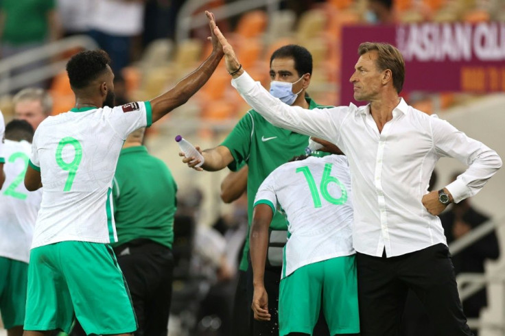 High-five for Saudi scorer Firas al-Buraikan from coach Herve Renard