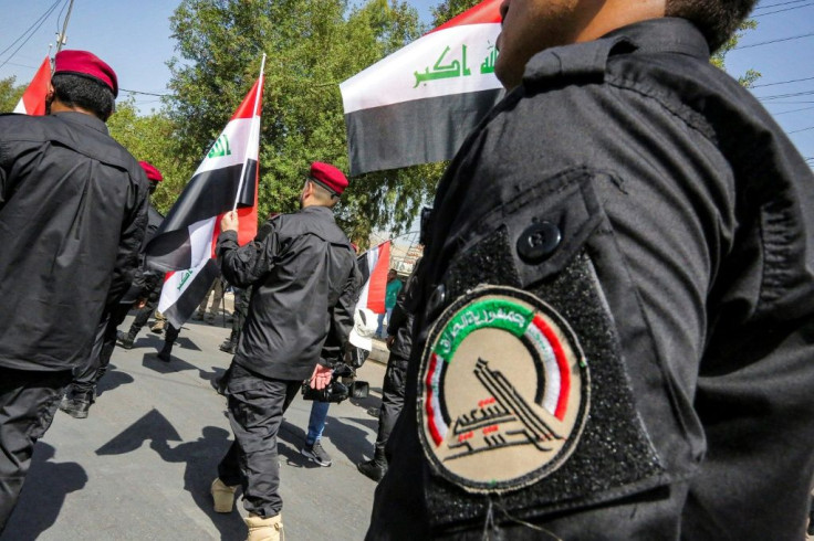 Members of Iraq's pro-Iranian Hashed al-Shaabi (Popular Mobilisation) paramilitary forces march in Baghdad in June