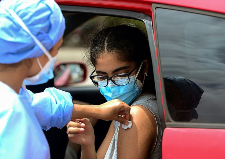 A teenager receives the first dose of the Pfizer/BioNTech Covid-19 vaccine in Tegucigalpa, on September 25, 2021