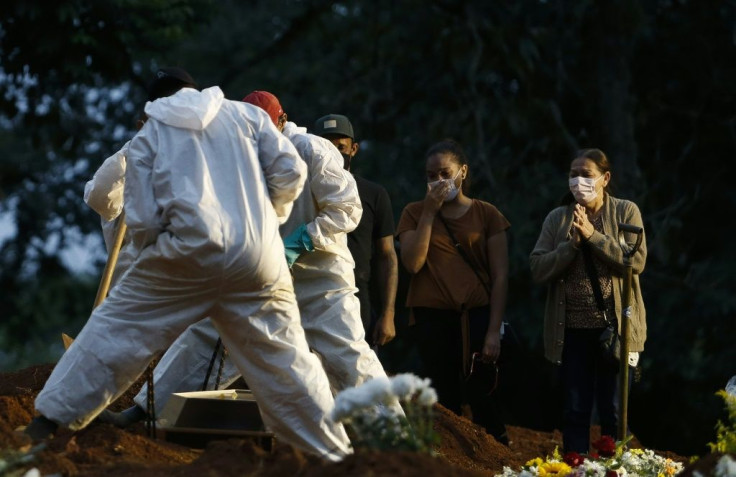 Relatives mourn as a Covid victim is buried in Sao Paulo, Brazil