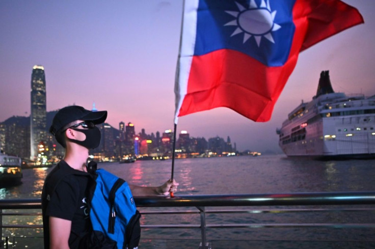 A masked man holds a Taiwanese flag at a 'Double Tenth' rally in 2019