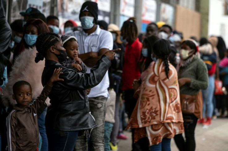 Haitian migrants queue in Tijuana, Mexico on October 6, 2021