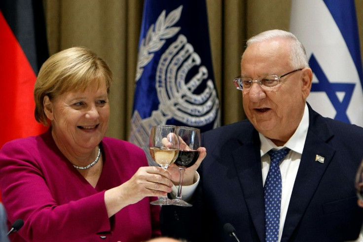 In this file photo taken on October 4, 2018, German Chancellor Angela Merkel raises a toast with then Israeli president Reuven Rivlin at the presidential compound in Jerusalem. Merkel is making a final visit to Israel as chancellor this weekend