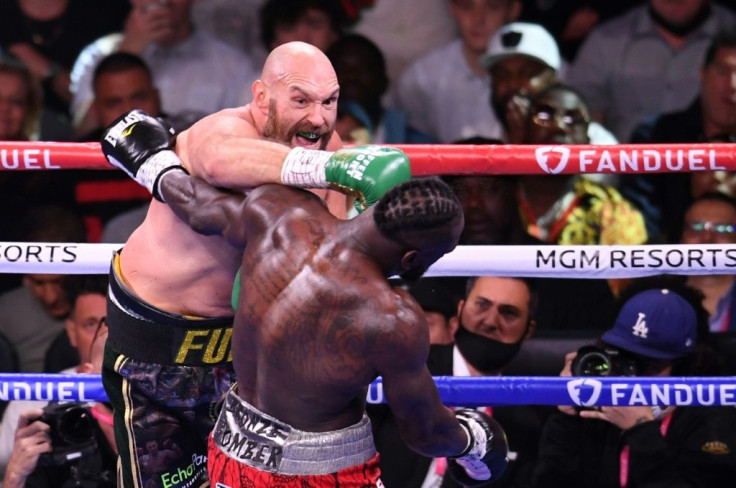 Britain's WBC heavyweight champion Tyson Fury lands an early punch on the way to an 11th-round knockout of US challenger Deontay Wilder
