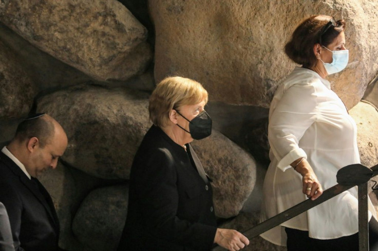 German Chancellor Angela Merkel and Israeli Prime Minister Naftali Bennett exit the Hall of Remembrance at the Yad Vashem Holocaust Museum in Jerusalem