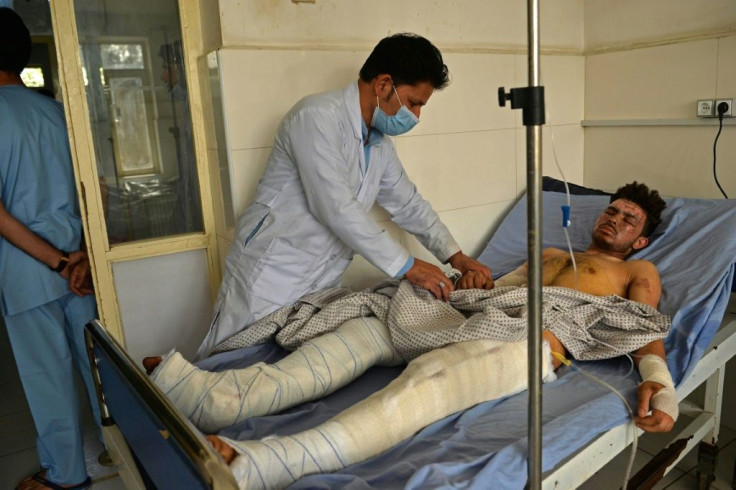 A doctor attends to a man injured in October 8 suicide bombing at the Gozar-e-Sayed mosque