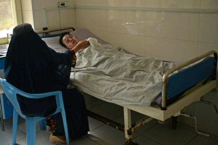 A woman tends to her relative who was injured during the suicide attack