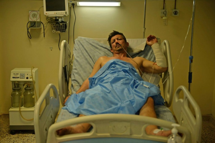 A victim who was injured in October 8 suicide bombing at the Gozar-e-Sayed mosque, rests inside a regional hospital in Kunduz