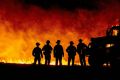 Fire fighters watch as flames quickly spread across a road at the Bear fire in Oroville, California in September 2020, one of a number of worsening disasters that experts have linked to climate change