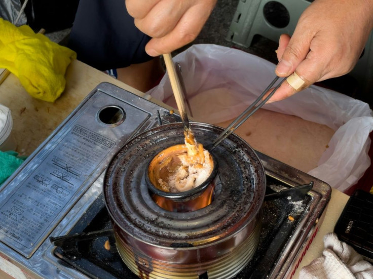 In about 90 seconds, Lim melts an individual portion of sugar above a burner, before adding baking soda, flattening it into a circle and cutting into a shape
