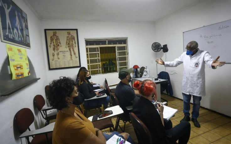 In addition to his work as a gravedigger, Brazilian Osmair Candido is a philosophy teacher, is writing a book and teaches future autopsy experts at a school in Sao Paulo