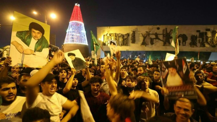 Supporters of Iraqi Shiite cleric Moqtada Sadr celebrate in Baghdad's Tahrir square on Monday after the announcement of parliamentary election results