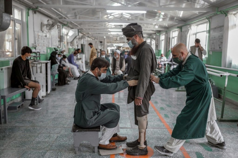 Members of an International Committee of the Red Cross Rehabilitation centre help a Taliban member who said he  lost his leg during a US forces strike