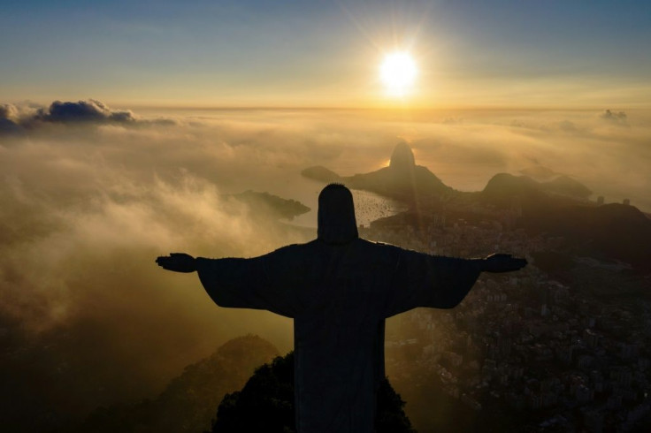In this file photo taken in March 2021, the sun rises in front of the Christ the Redeemer statue in Rio de Janeiro, Brazil