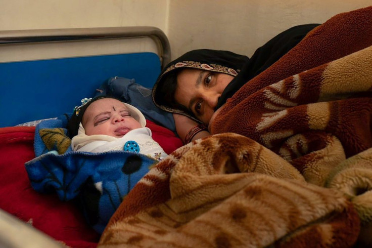 A mother with her newborn rests at the Tangi Saidan clinic