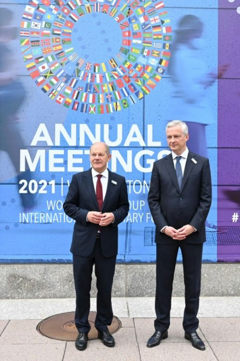 French Finance Minister Bruno Le Maire (right) speaks with German Finance Minister Olaf Scholz (left) outside IMF headquarters in Washington