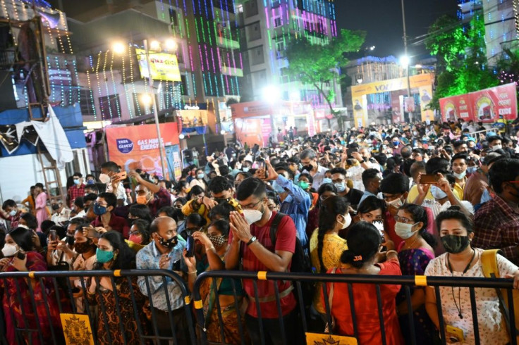 People throng a makeshift place of worship during the Durga Puja festival in Kolkata