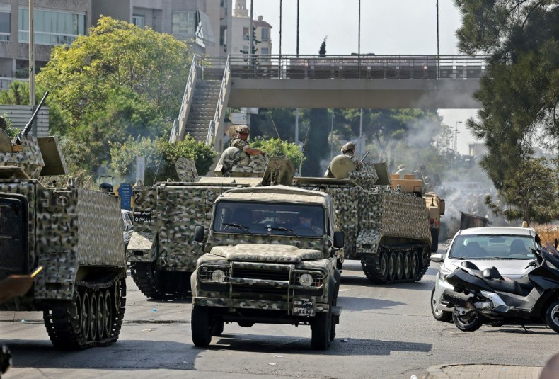 An armoured column of Lebanese troops deploys to Tayouneh, in the mainly Shiite southern suburbs of Beirut, after deadly violence erupts at a protest demanding the replacement of the lead investigator into last year's monster port blast