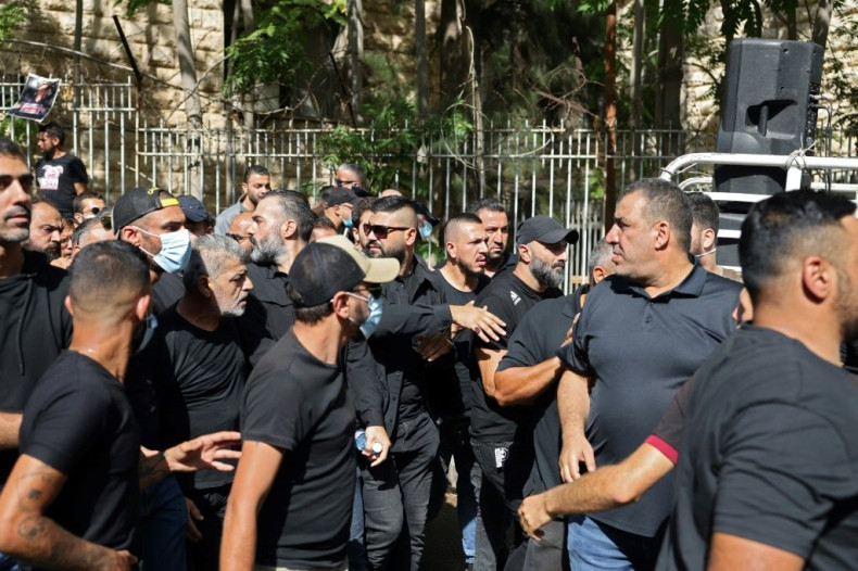 Supporters of Shiite groups Hezbollah and Amal demonstrate outside Lebanon's Palace of Justice demanding the replacement of the lead investigator into last year's monster Beirut port explosion
