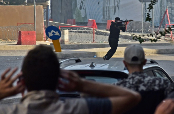 A Shiite activist armed with a rocket-propelled grenade launcher moves along a street in the Tayouneh area of Beirut