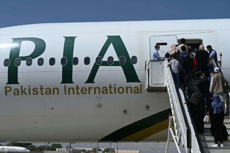 Passengers board a Pakistan International Airlines (PIA) flight at Kabul airport