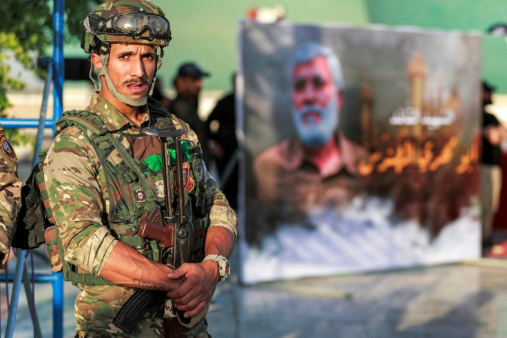 A member of Iraq's Hashed al-Shaabi (Popular Mobilisation) paramilitary forces stands guard during an election rally for the Asaib Ahl al-Haq movement in Baghdad on October 7, 2021