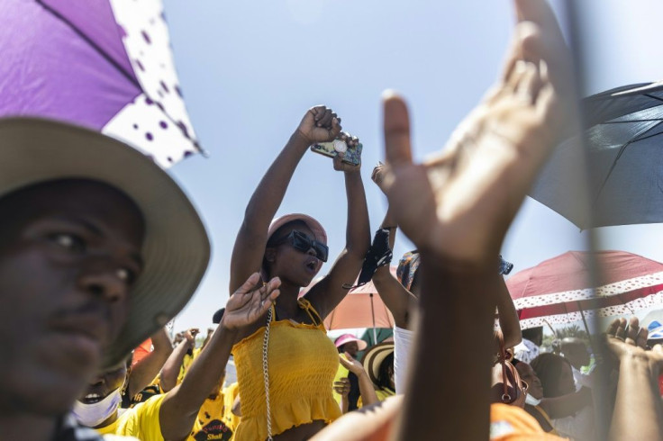 People sing during a collective 'welcome prayer' for Zuma