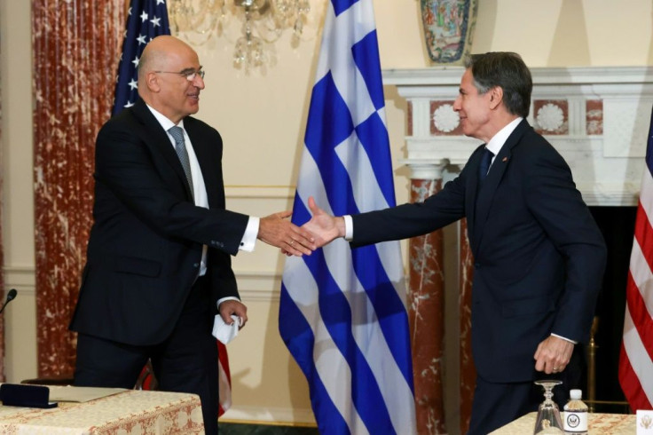 US Secretary of State Antony Blinken and Greek Foreign Minister Nikos Dendias shake hands after signing the renewal of the US-Greece Mutual Defense Cooperation Agreement at the State Department