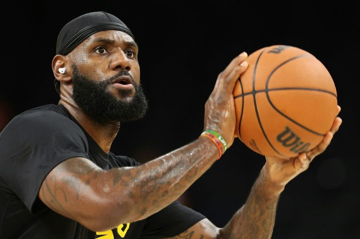 Basketball star LeBron James warms up on the court before a game in Phoenix, Arizona in October 2021