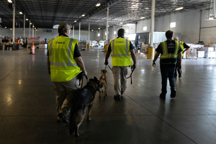 Dogs search cargo coming off international flights at Rickenbacker International Airport, where shipments that would normally come by sea have arrived by air