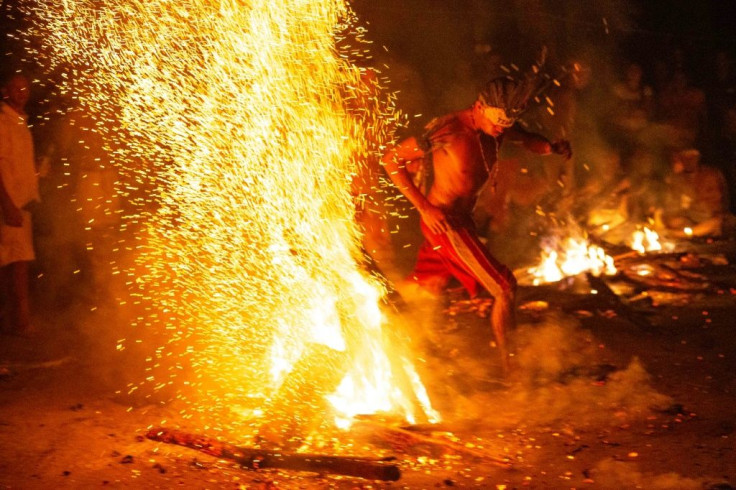 Worshippers dance around a bonfire to honor the Maria Lionza goddess on the 'magical' Sorte mountain in northwestern Venezuela