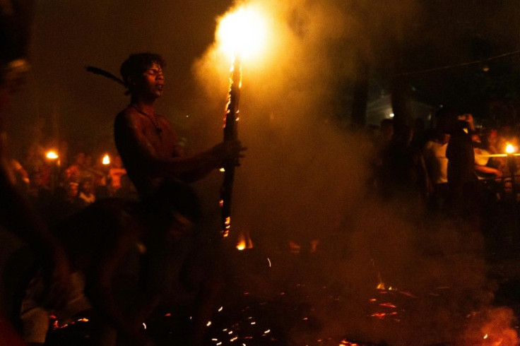 Ritual participants walk on fire as part of the traditional 'candlelight dance' to worship the Maria Lionza goddess