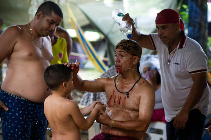 Tilo Pereira (center) invokes the viking spirit in a ritual that involves piercing his cheek with a large needle