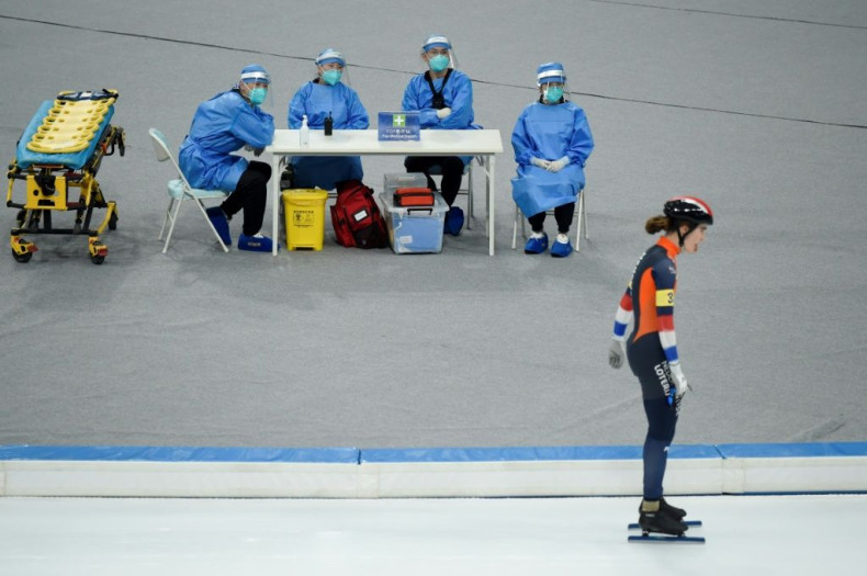 Medical staff watch a Dutch skater glide past