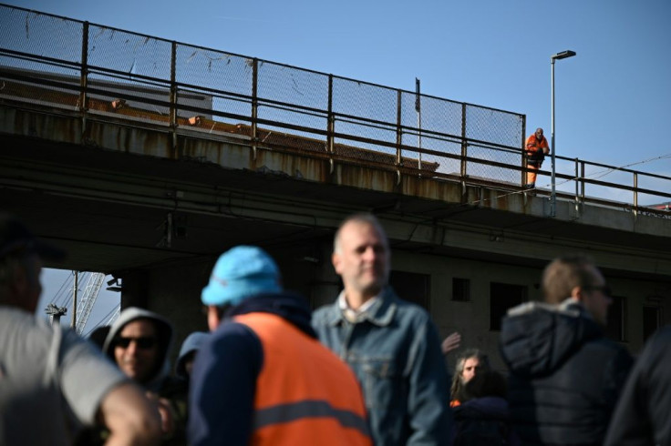 Roughly 300 people blocked an entrance to the port of Genoa in the northwest, causing delays