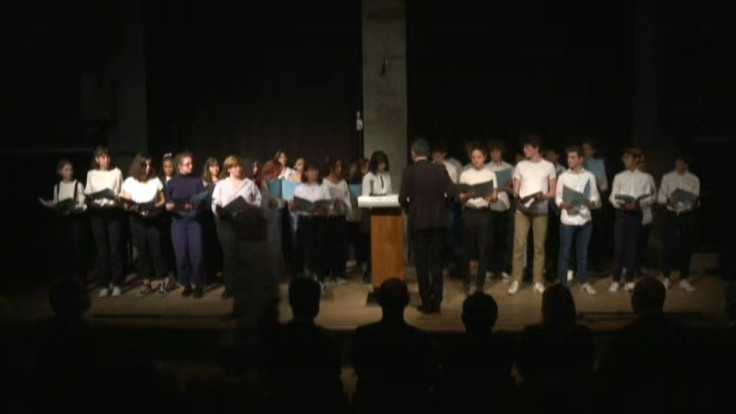 On a day of nationwide tributes to Paty, a  choir performs in a Paris high school