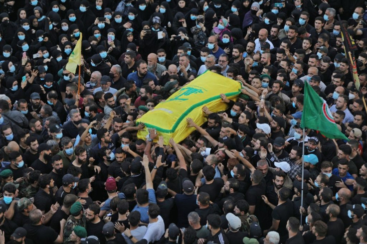 Supporters of Lebanon's Hezbollah movement on Friday carry the coffin of one of their members who was killed during clashes in Beirut's Tayouneh neighbourhood a day earlier